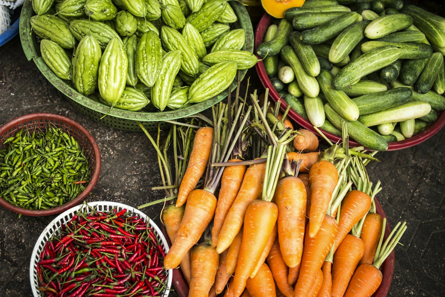 Baskets of fresh-harvested vegetables at a farm market
